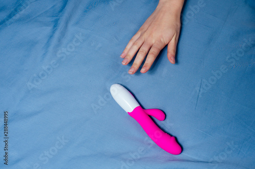 Tableau sur toile woman and man reaches for the bedside table for sex toy