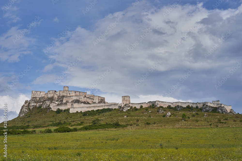 The ruins of Spis Castle in eastern Slovakia taken in summer day, in the region known as Spis, one of the largest castle sites in Central Europe included in the UNESCO list of World Heritage Sites. The ruins of Spis Castle in eastern Slovakia taken in summer day, in the region known as Spis, one of the largest castle sites in Central Europe included in the UNESCO list of World Heritage Sites.