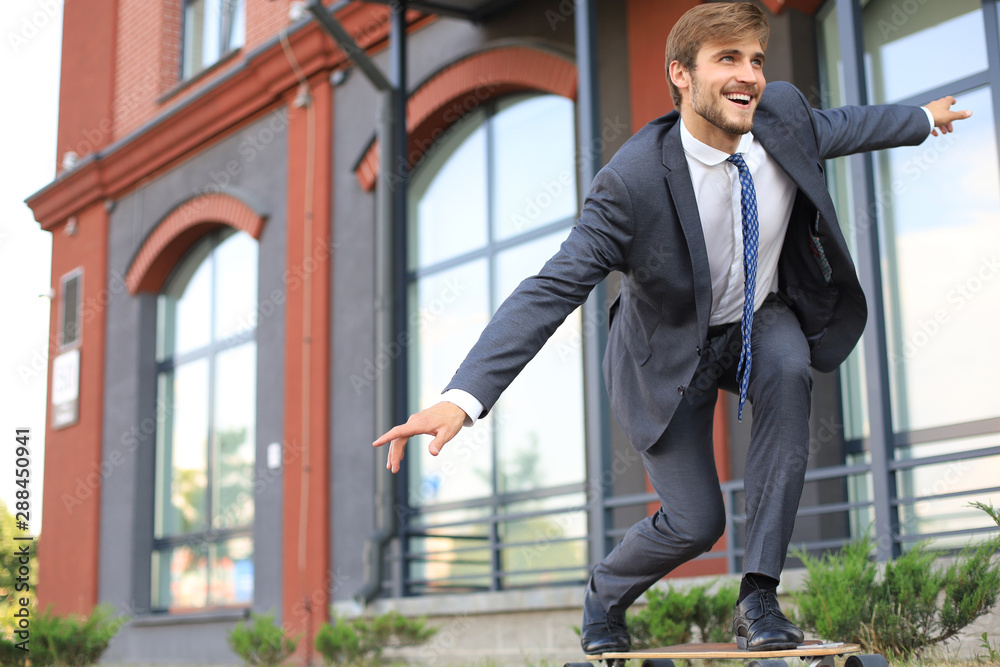Confident young businessman in business suit on longboard hurrying to his office, on the street in the city. Confident young businessman in business suit on longboard hurrying to his office, on the street in the city.