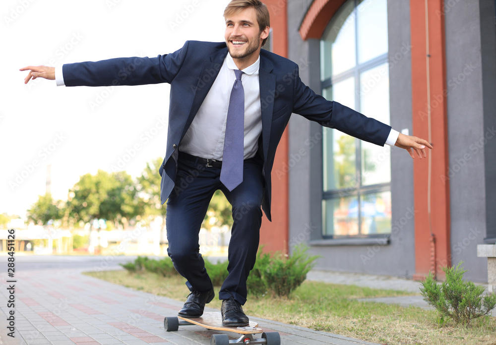 Confident young businessman in business suit on longboard hurrying to his  office, on the street in the city. Stock Photo | Adobe Stock