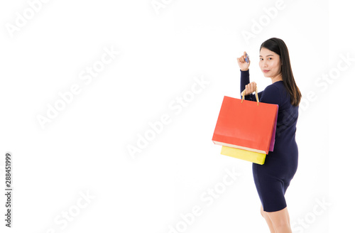 Woman with shopping bags and credit cards in white background Happy with shopping