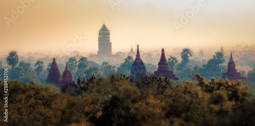 Silhouettes of ancient Buddhist temples in Bagan, Myanmar during sunset. Aerial view. Panoramic landscape