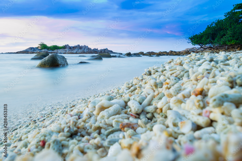 Empty and tranquil beach on the Malaysian tropical paradise Perhentian Islands during sunset, long exposure