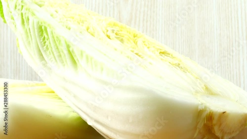 Napa cabbage, shooting in the movement. Cuttig board. photo