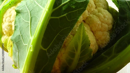 Shooting of cauliflower in the movement. Cuttig board. photo