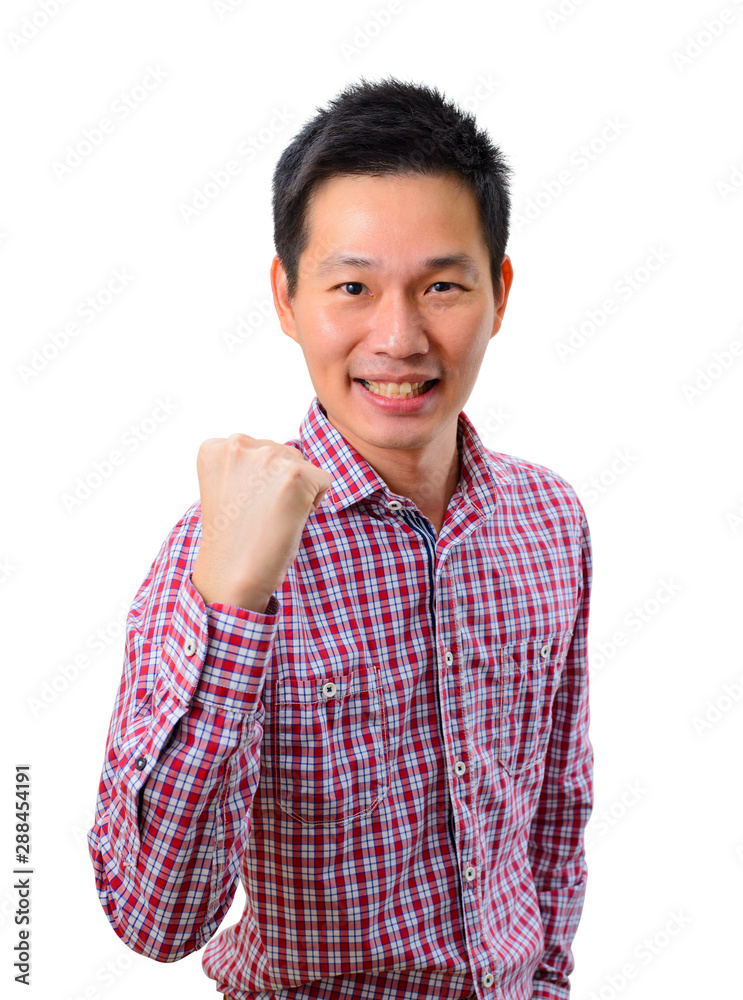 Happy excited young Asian man raising his fists doing yes gesture celebrating success Happy excited young Asian man raising his fists doing yes gesture celebrating success