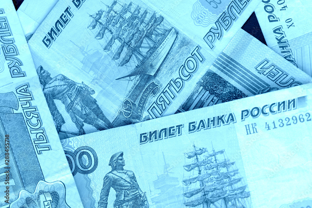 Fototapeta premium Banknote background from Russian rubles close up. Blue color toned