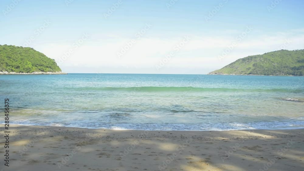 Beauty of tropical Yanui Beach waves breaking on a seashore at west coast of phuket under blue sky in the morning, Thailand. Beauty of tropical Yanui Beach waves breaking on a seashore at west coast of phuket under blue sky in the morning, Thailand.