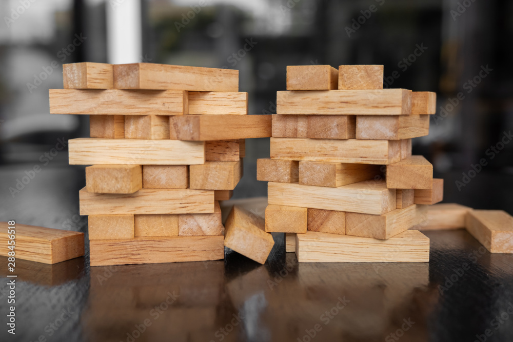 Wood block pile with architecture model with classic black tone background, Concept Risk management and strategy plan, growth business success process and team work Wood block pile with architecture model with classic black tone background, Concept Risk management and strategy plan, growth business success process and team work