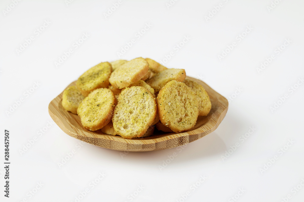 wood plate of crusty bread bruschetta on white background