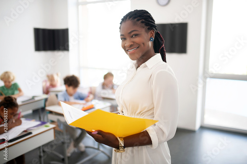 Beautiful teacher smiling while enjoying the lesson photo