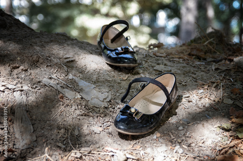 pass, abandoned child's shoes on the street. One pair of abandoned baby shoes could symbolize a missing child