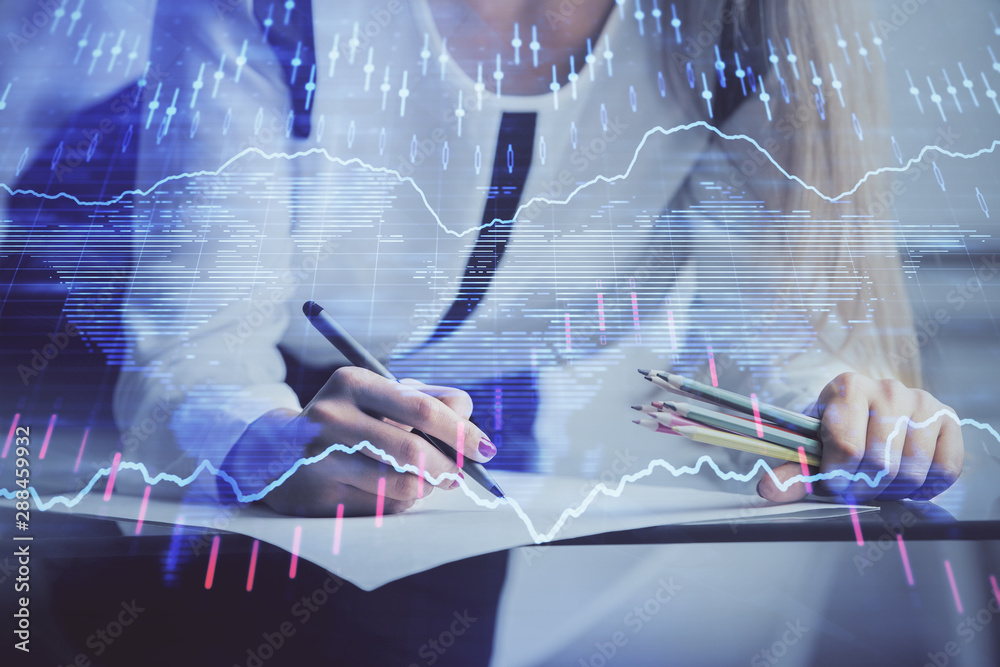 Double exposure of hands making notes with forex chart huds. Stock market concept. Double exposure of hands making notes with forex chart huds. Stock market concept.