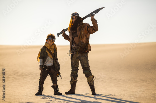 Post-apocalyptic Woman and Boy Outdoors in a Wasteland
