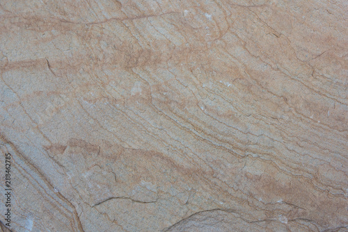 Weathered rock and sandstone wavy stripes closeup background