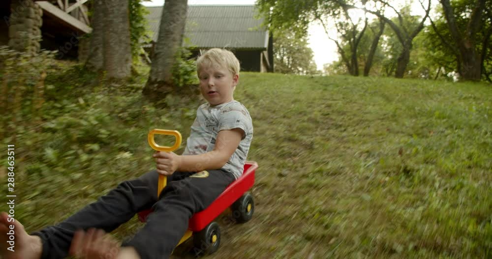 Boy has fun - Drive down hill, tracking shot Boy has fun - Drive down hill, tracking shot