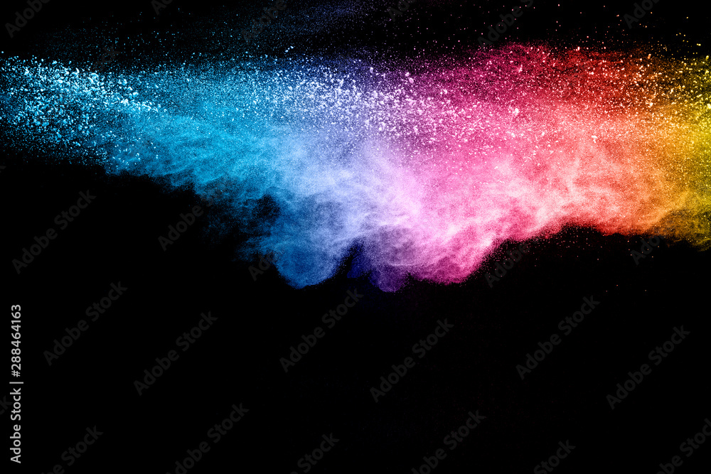 Colorful background of pastel powder explosion. Rainbow color dust splash on black background.