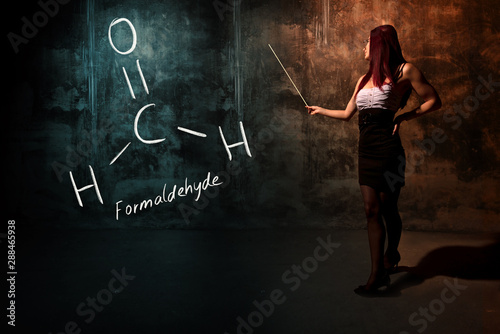 Sexy girl or secretary or female student presenting handdrawn chemical formula of Formaldehyde photo