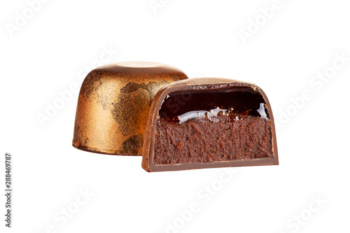 Cut luxury handmade bonbon with chocolate ganache and liquid filling isolated on white background