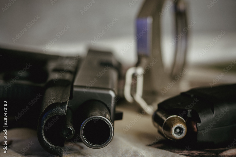 Obraz premium Police and security pistol magazine and handcuffs