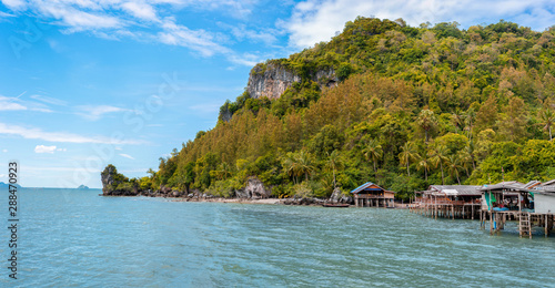 Island tropical beach with fisher village and nice blue sky, Klam bay Chumphon Thailand photo