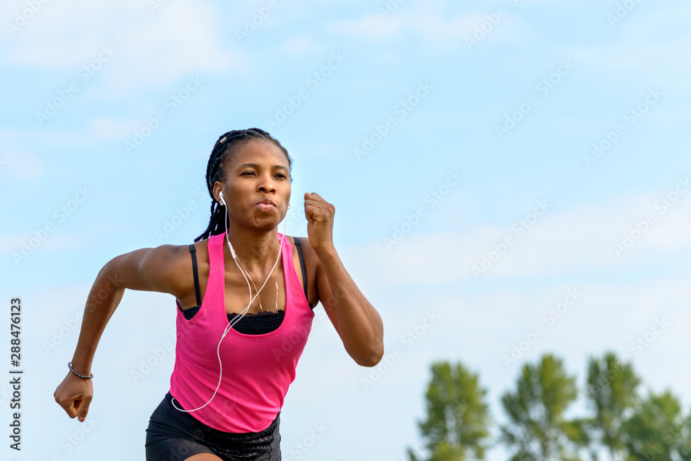 Fit determined young African woman jogging Fit determined young African woman jogging
