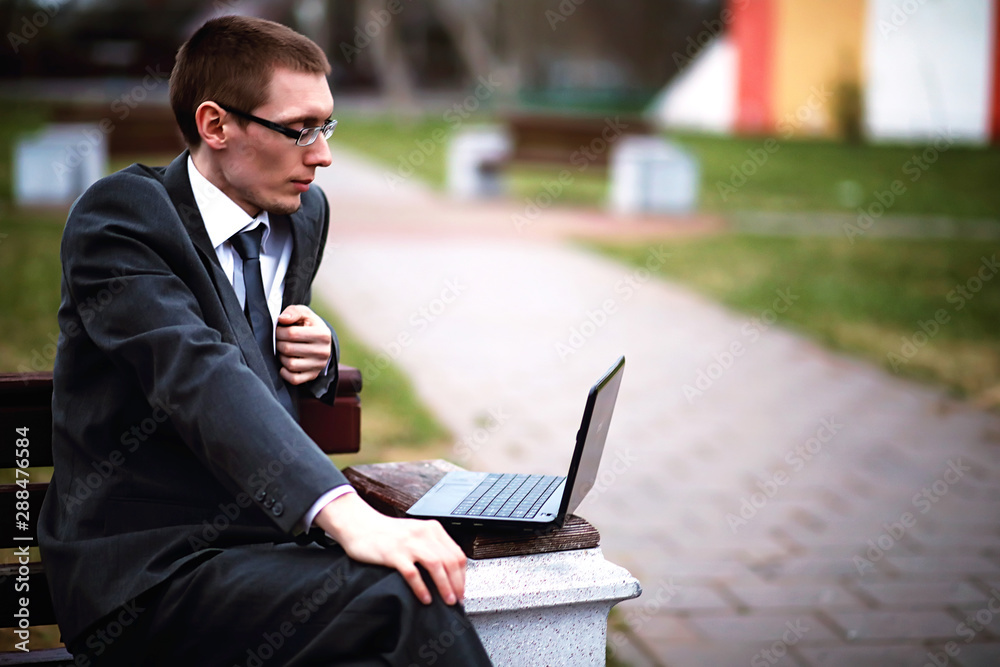 A man in a suit lies on a brick floor