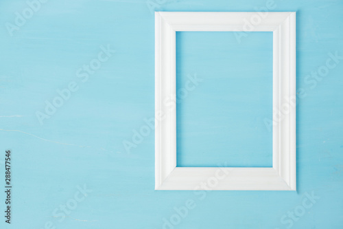 Vintage white mockup  frame on blue wooden bacground