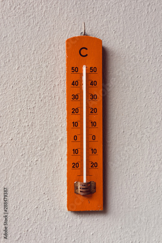 Red Termometer hangin on a wall