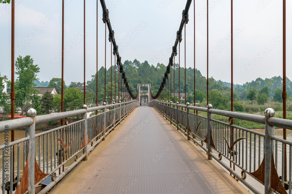 Obraz premium Iron rope suspension bridge in the ancient town of Huanglongxi, Chengdu, Sichuan Province, China
