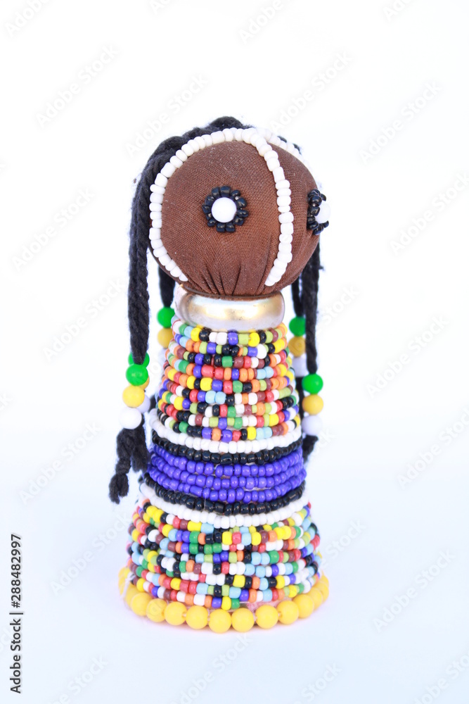 Fototapeta premium Beaded colorful African doll isolated on a white background