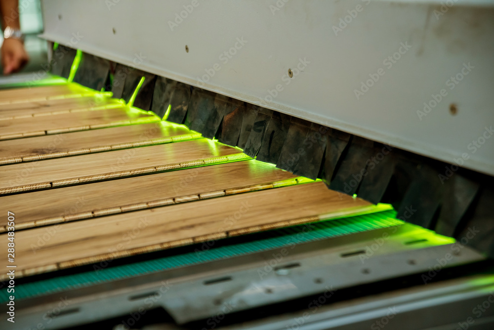 Production line of the wooden floor factory. CNC automatic woodworking machine. Production line of the wooden floor factory. CNC automatic woodworking machine.