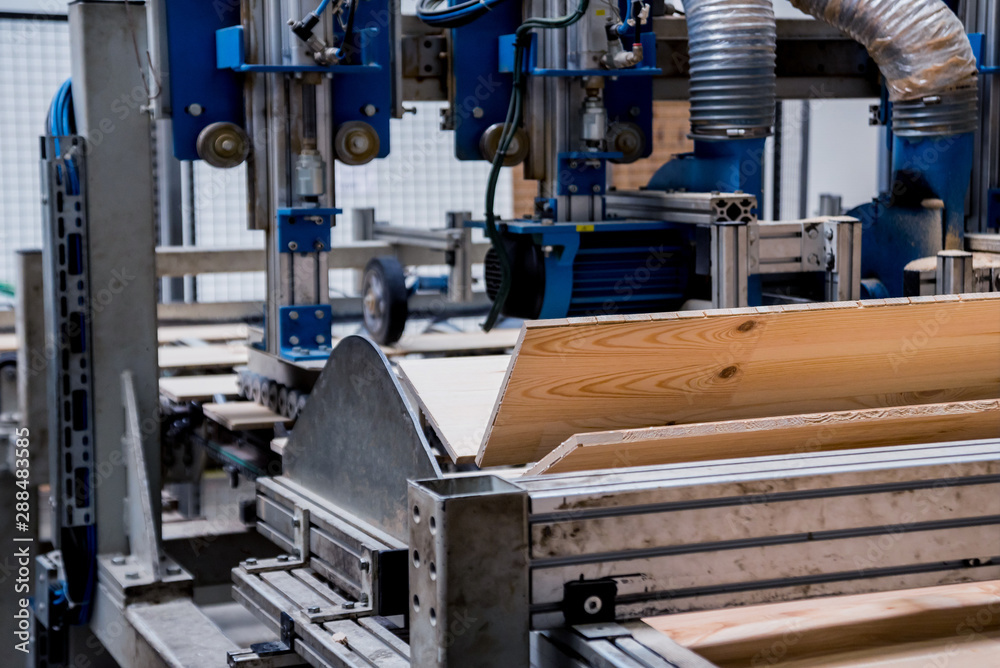 Production line of the wooden floor factory. CNC automatic woodworking machine. Production line of the wooden floor factory. CNC automatic woodworking machine.