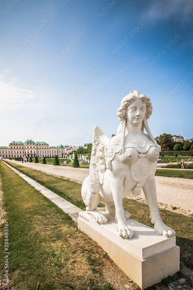 Obraz premium Beautiful white statue with a lion body and a female head. Ancient sculpture in the park