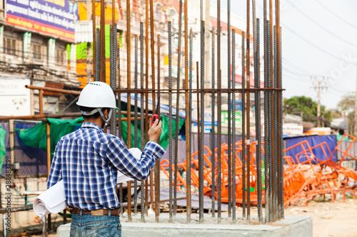 construction supervisor engineers check the project work and use the radio to coordinate with foreman to plan the work