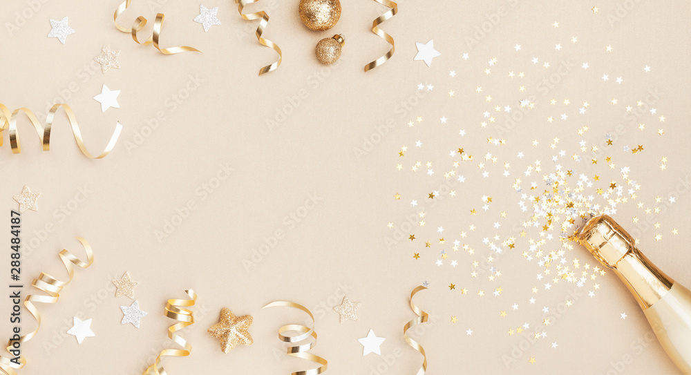 Champagne bottle with confetti stars, holiday decoration and party streamers on gold festive background. Christmas, birthday or wedding concept. Flat lay. - obrazy, fototapety, plakaty 
