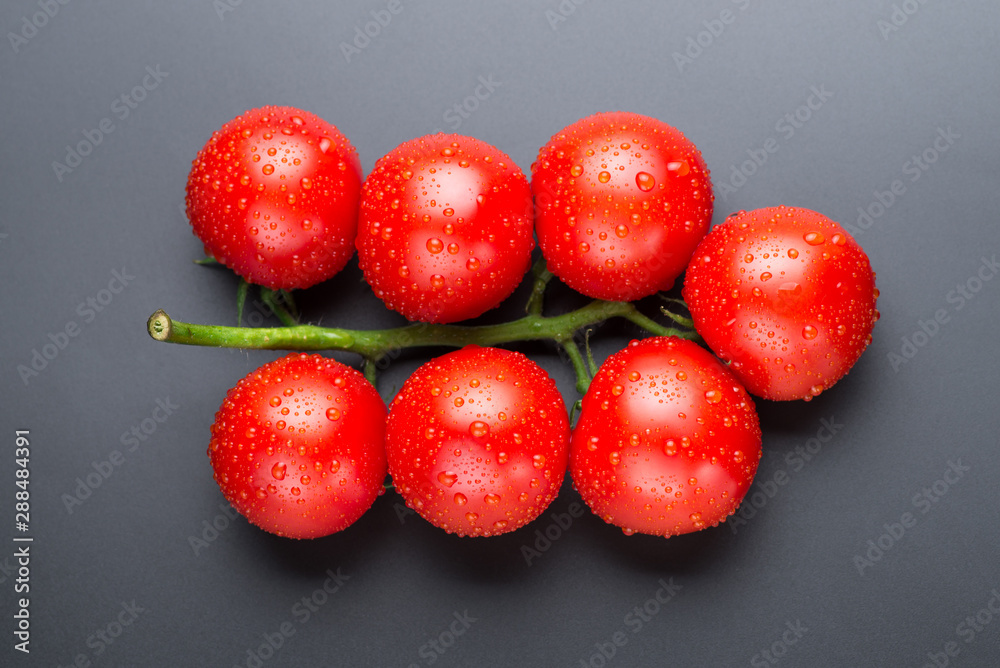 Beautiful red tomatoes with drops on a black background. Beautiful red tomatoes with drops on a black background.