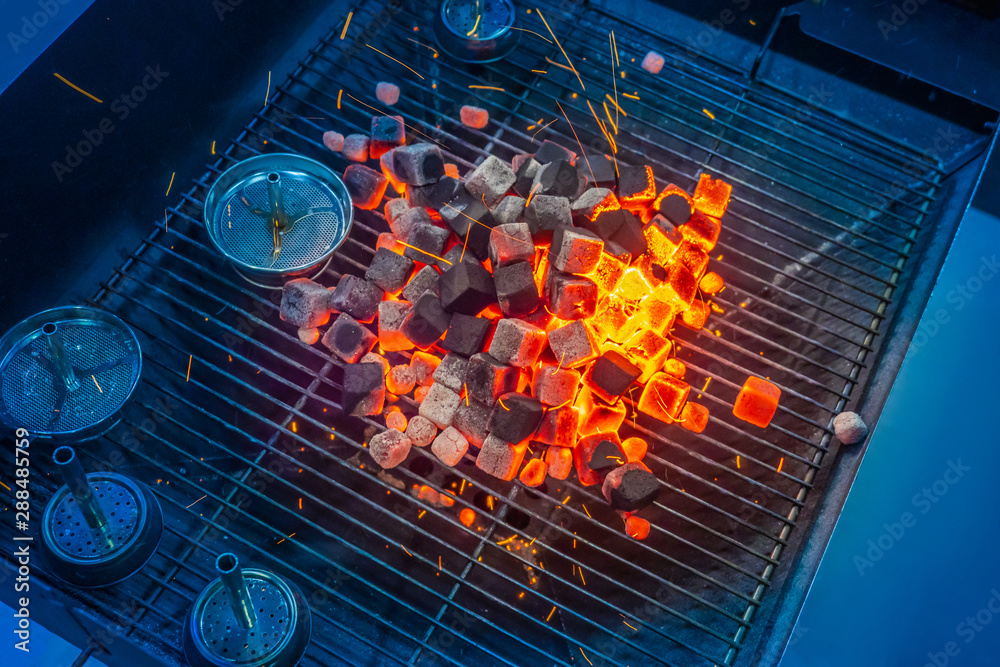 Stockfoto Kindle coal for a hookah. Coal cubes for hooka. Hot coals for