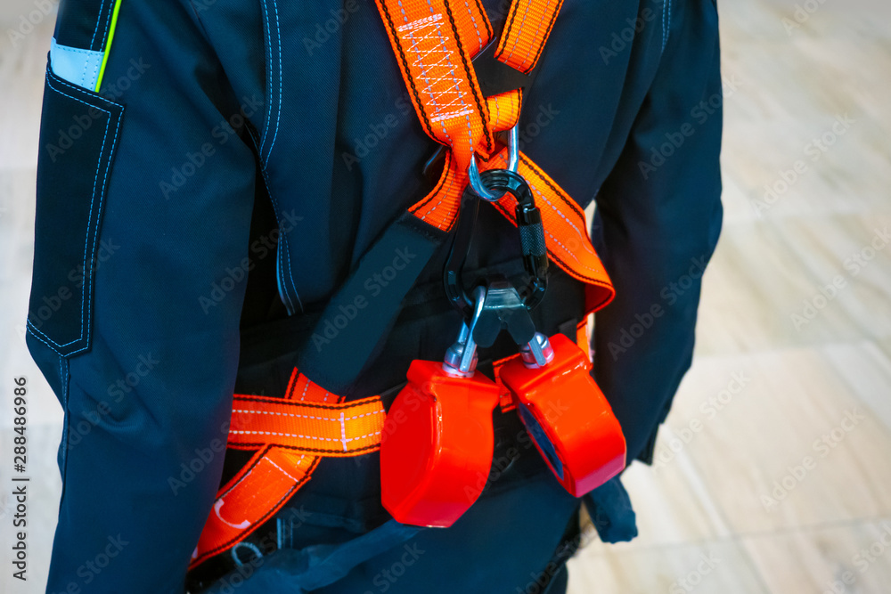 The belt is safety. Fragment of a safety belt.Construction strap with shoulder straps. Inventory for builders.Safeness at work.Safety belt. High-altitude work.Fall protection.Equipment for the erector The belt is safety. Fragment of a safety belt.Construction strap with shoulder straps. Inventory for builders.Safeness at work.Safety belt. High-altitude work.Fall protection.Equipment for the erector