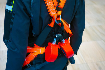 The belt is safety. Fragment of a safety belt.Construction strap with shoulder straps. Inventory for builders.Safeness at work.Safety belt. High-altitude work.Fall protection.Equipment for the erector