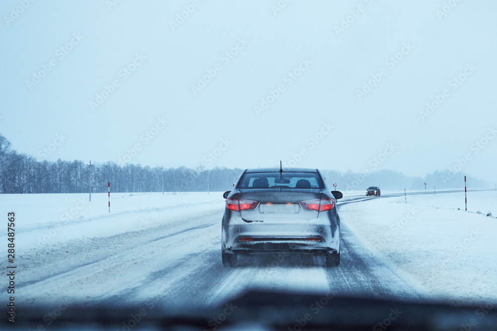 Back view of car on snowy winter road