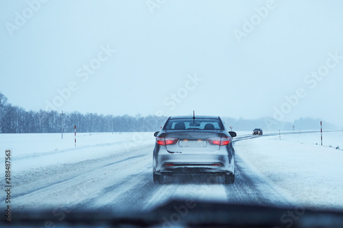 Back view of car on snowy winter road