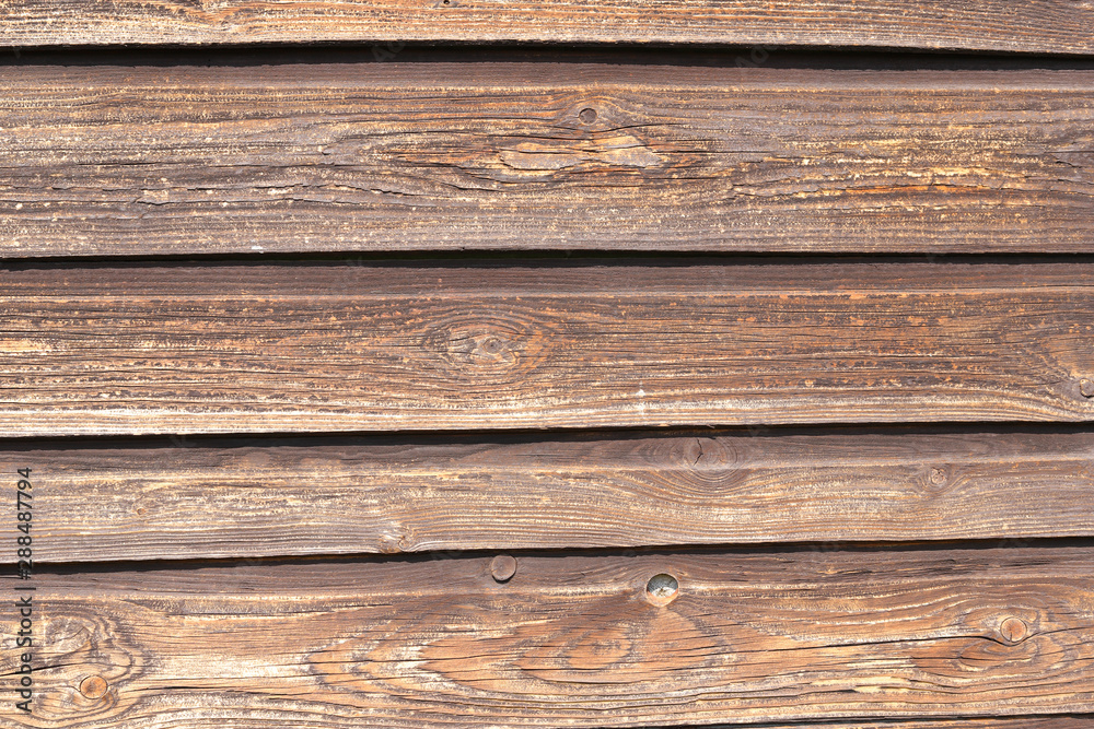 Obraz premium fragment of an old wooden wall from unpainted horizontal boards