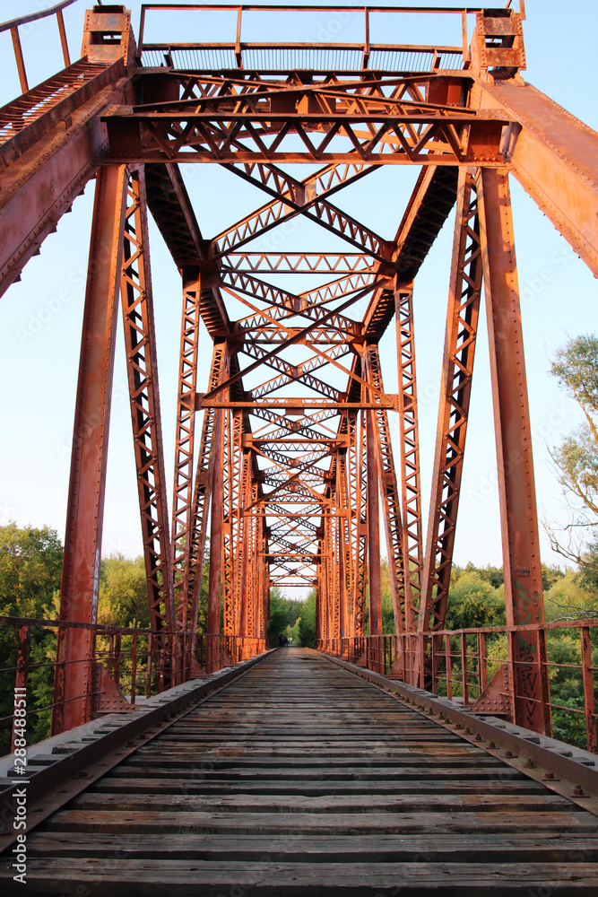 Red suspension bridge across the river