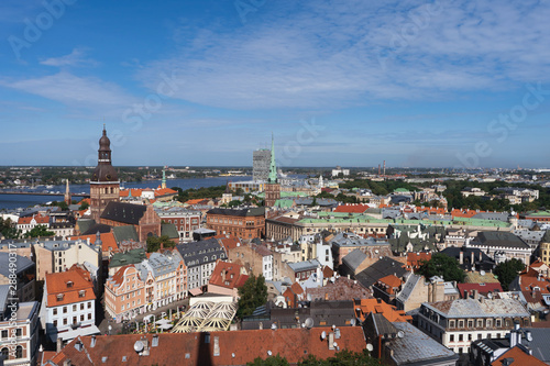 Riga, Latvia. Summer. Panoramic view of the city. The streets of the old city aerial view. River, houses, old churches, blue sky. Postcard. Free space for text.