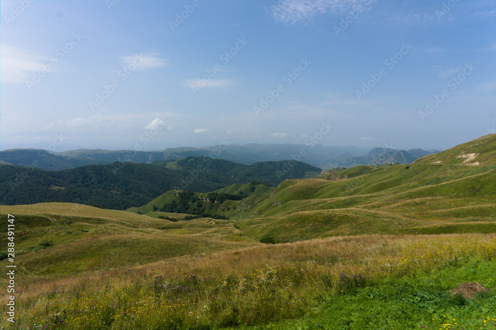 Gumbashi pass view in the russian caucasus, green meadow landscape at an altitude of above 2000 m