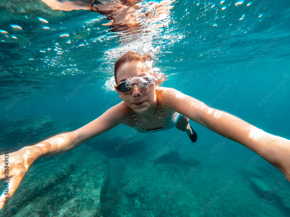 Girl swimming in the sea water