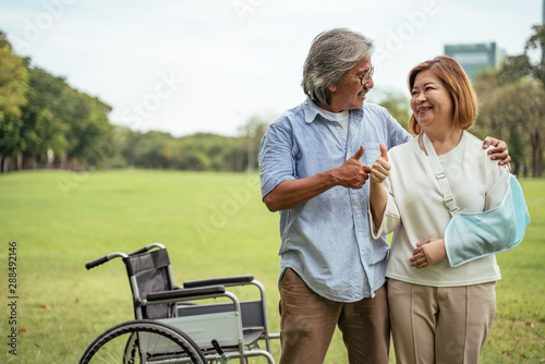 Lifestyle sian senior couple happy and relaxed concept. Good Healthy elderly in park nature.senior couple holding their thumbs up.