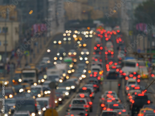 Blurred photography of cars motion. Big traffic in city. In the summer urban highway filled cars. Rush hours. To be late. Suitable for greeting card design, background, postcard template, poster