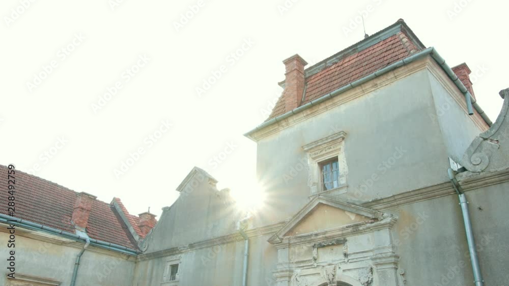 old castle, with battered walls and red roof, old large gates and Windows old castle, with battered walls and red roof, old large gates and Windows